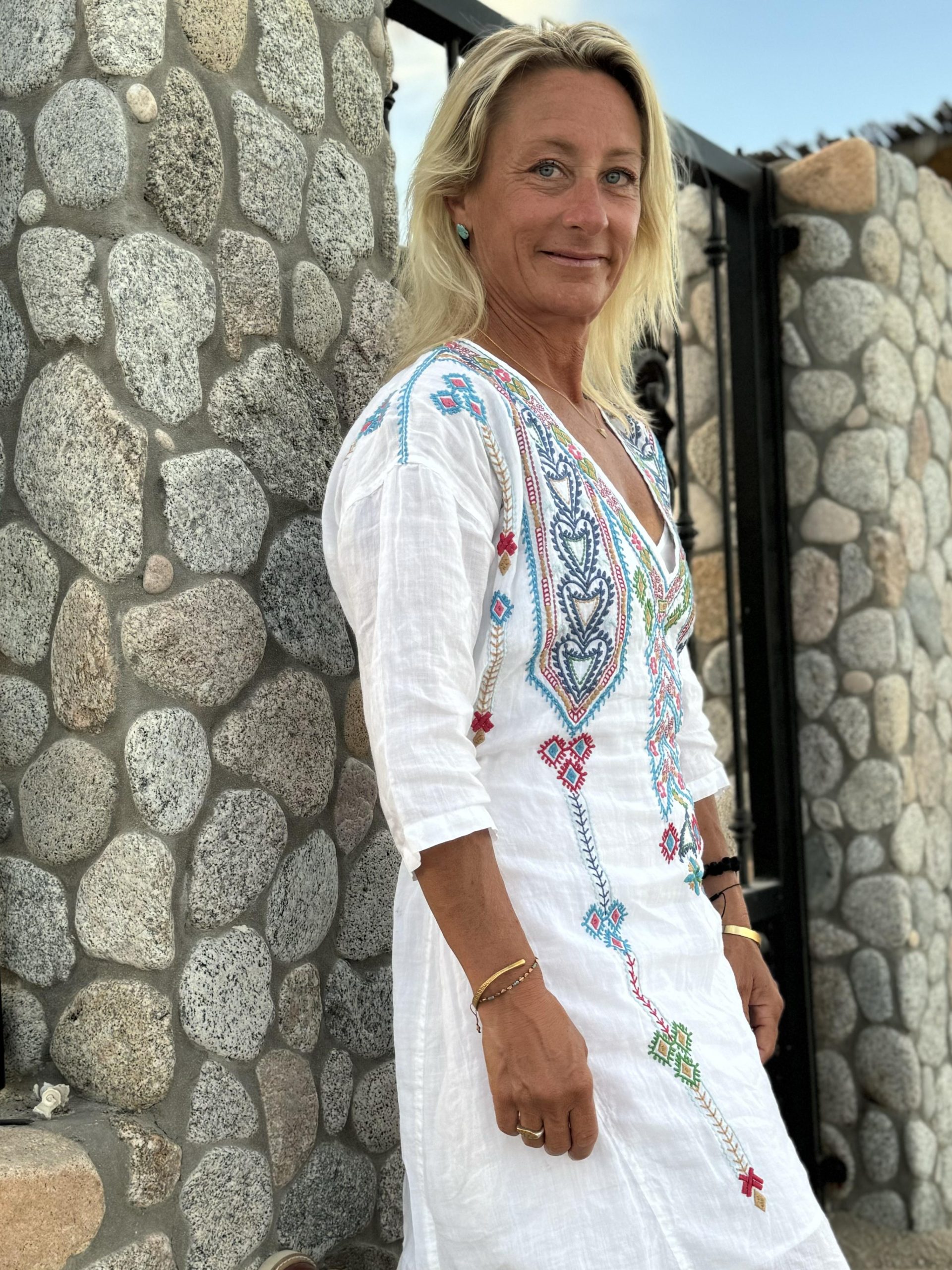 Rachel Salzberg Standing Next to Stone Wall
