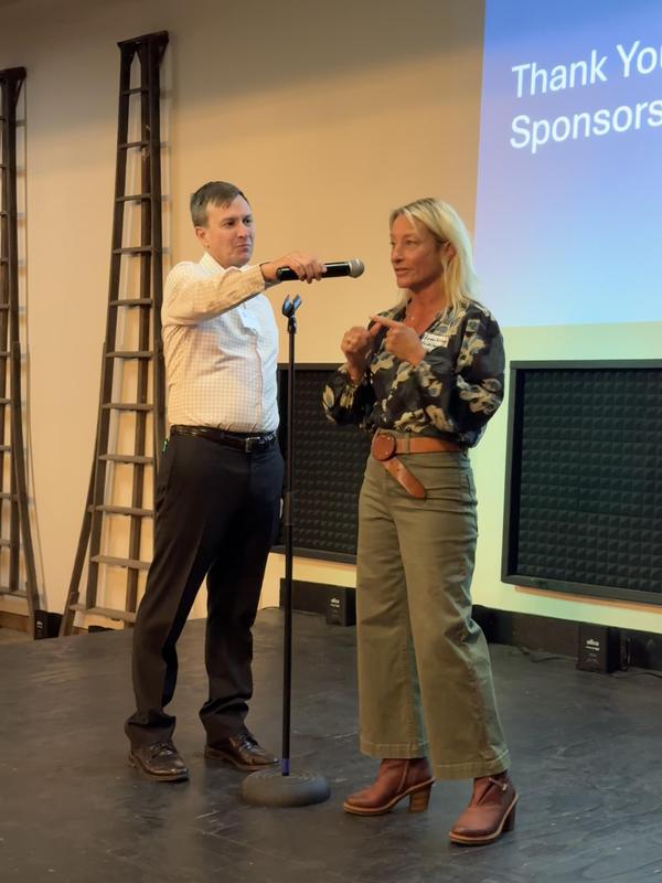 Rachel Speaking On Stage Microphone